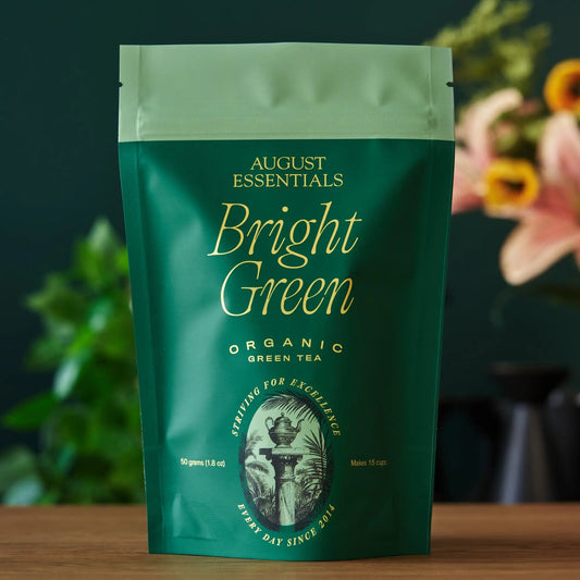 Essentials Bright Green kukicha green tea bags packaging, organic tea, 15 cup size, featuring a green backdrop.