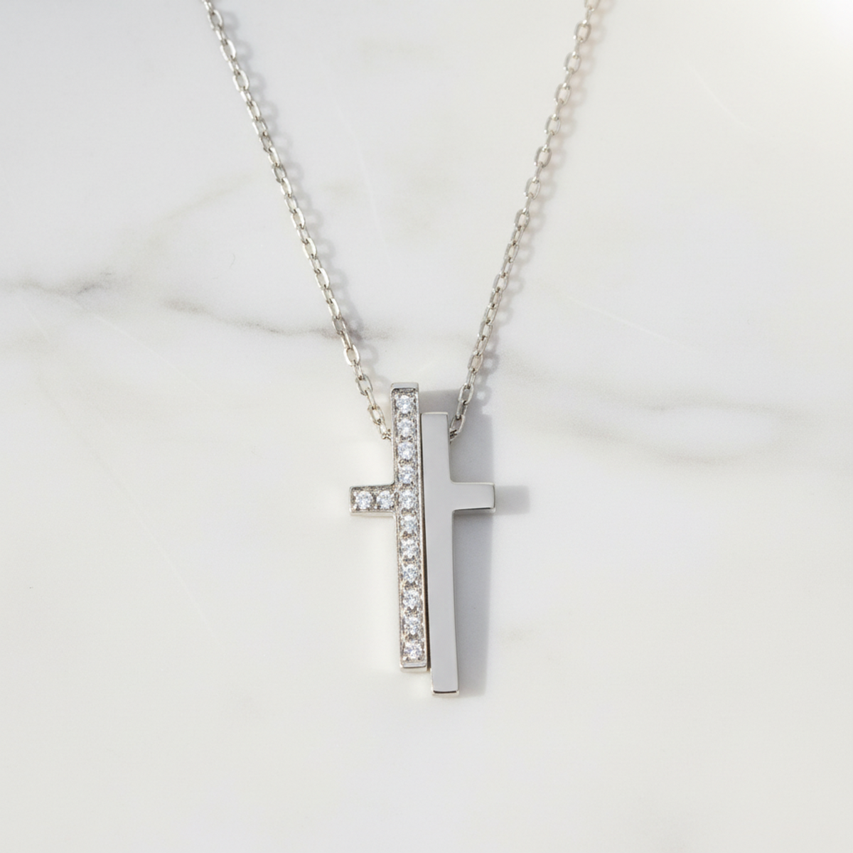 Gucci diamond necklace 18K white gold with diamond cross pendant on a silver chain.