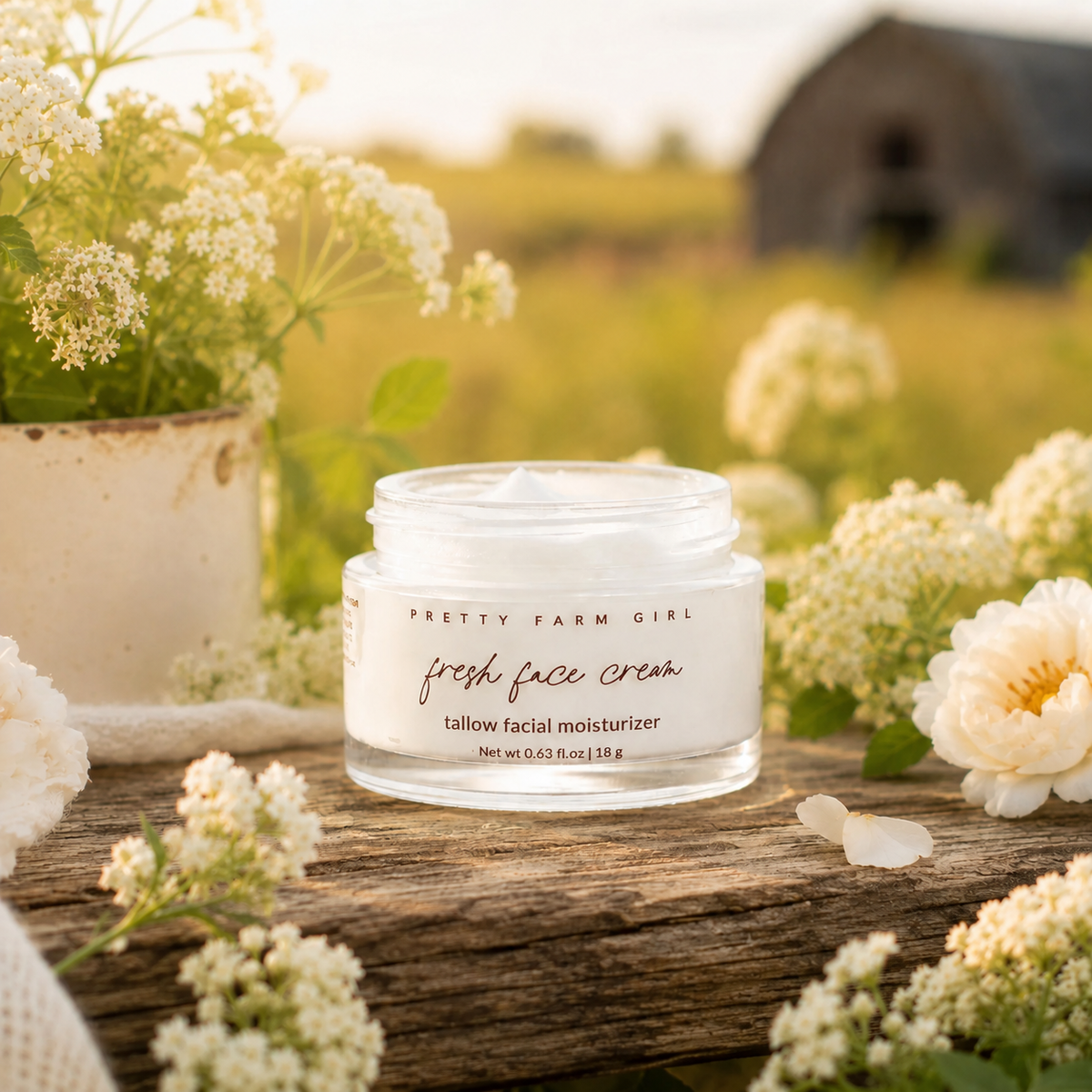 Fresh Face Cream anti-aging tallow moisturizer in a natural setting with flowers.