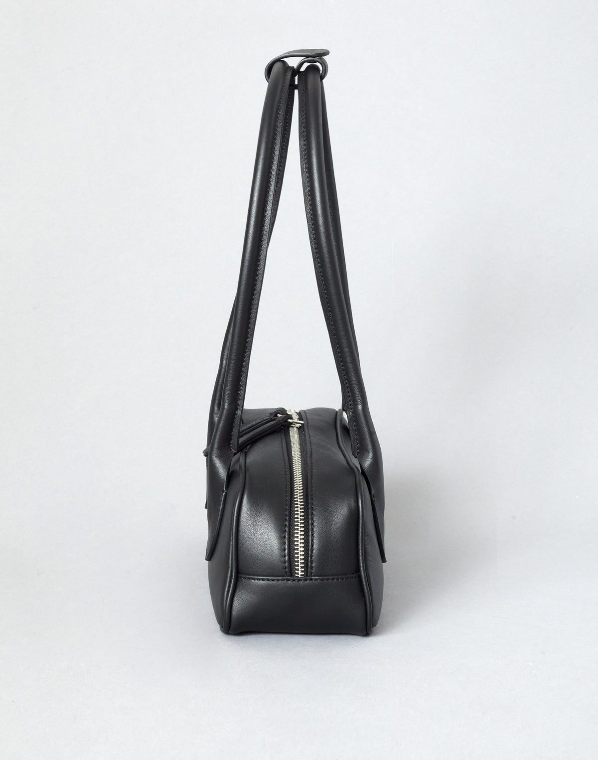 Mini La Strada structured leather baguette bag with double-zip closure and long shoulder straps.