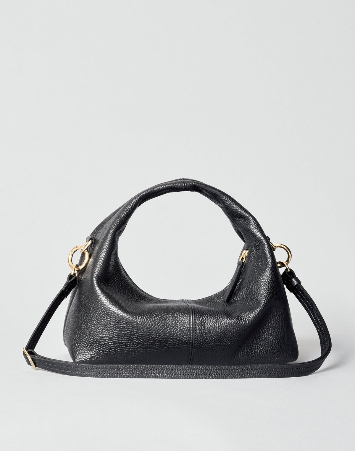Mini everyday shoulder bag in black leather with slouchy silhouette and gold hardware.