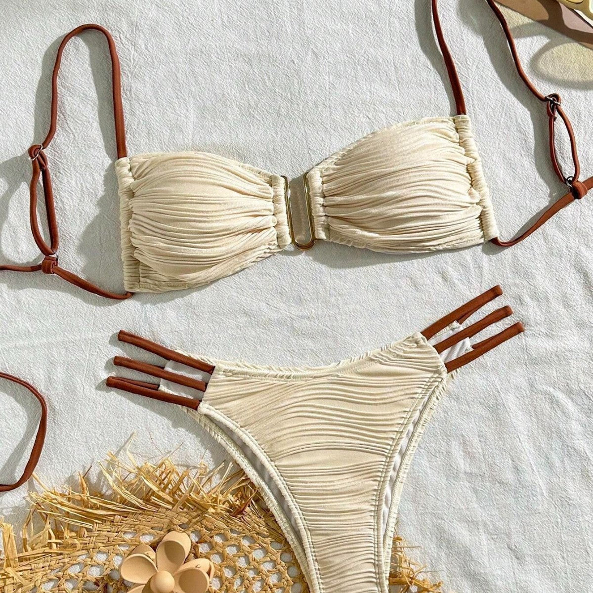 Three-piece sexy swimsuit for women featuring a stylish bandeau top and matching bottom in a light color scheme.
