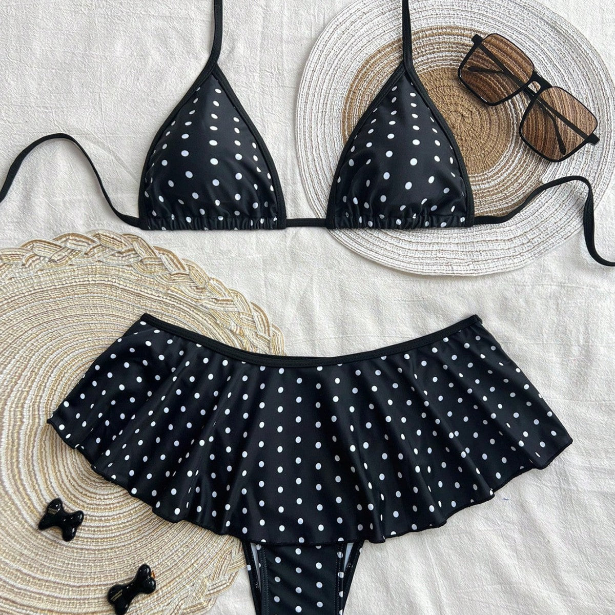 leopard print skirted bikini swimsuit in black and white polka dots with sunglasses and straw accessories