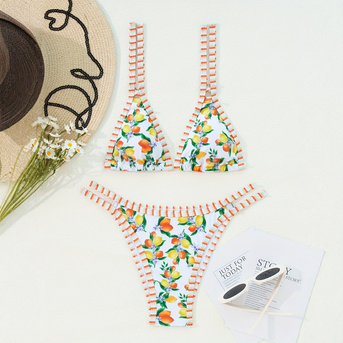 Sexy printed bikini swimsuit set with triangle top and matching bottom featuring floral design.