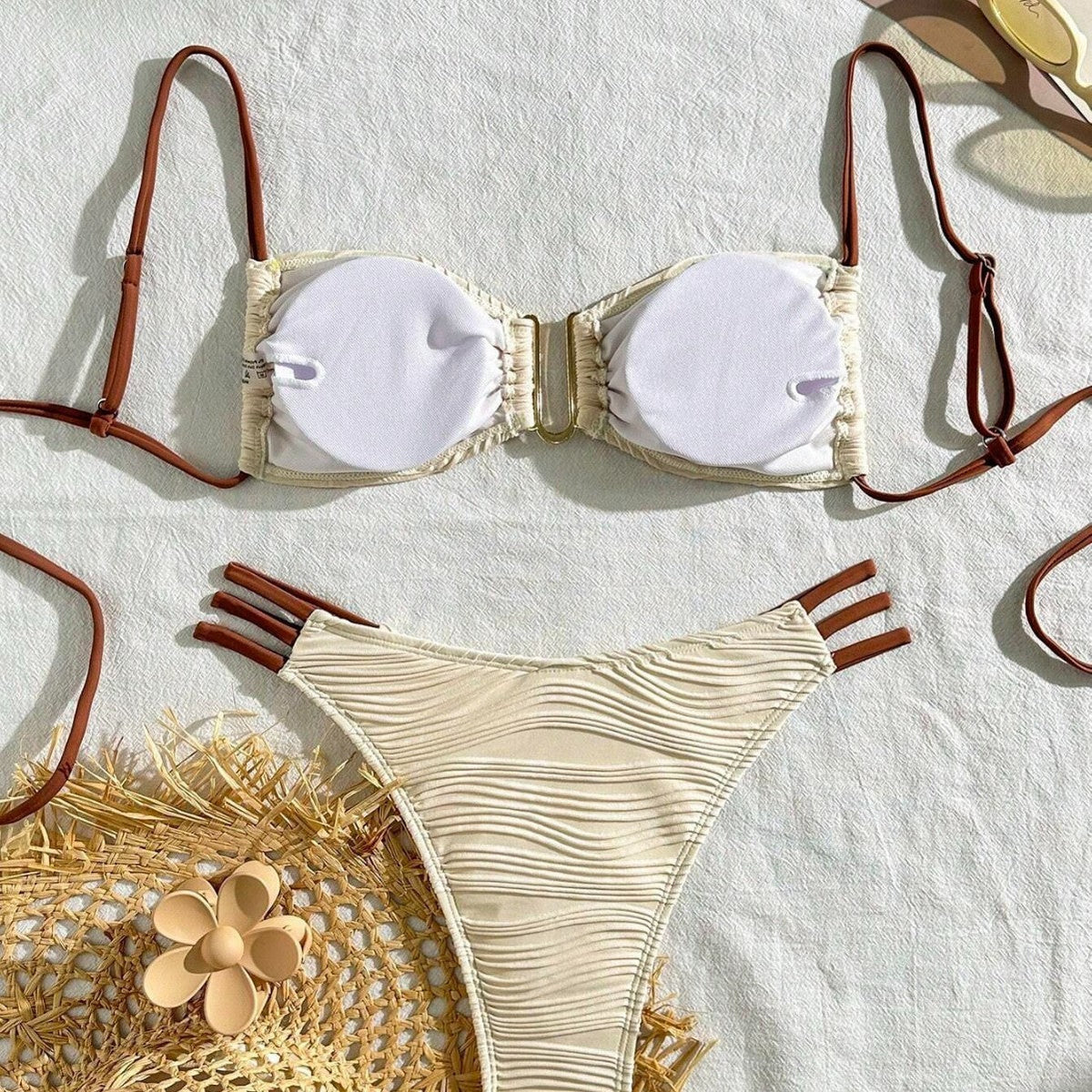 Three-piece sexy swimsuit for women featuring a comfortable bralette and stylish high-waisted bottom on a light background.