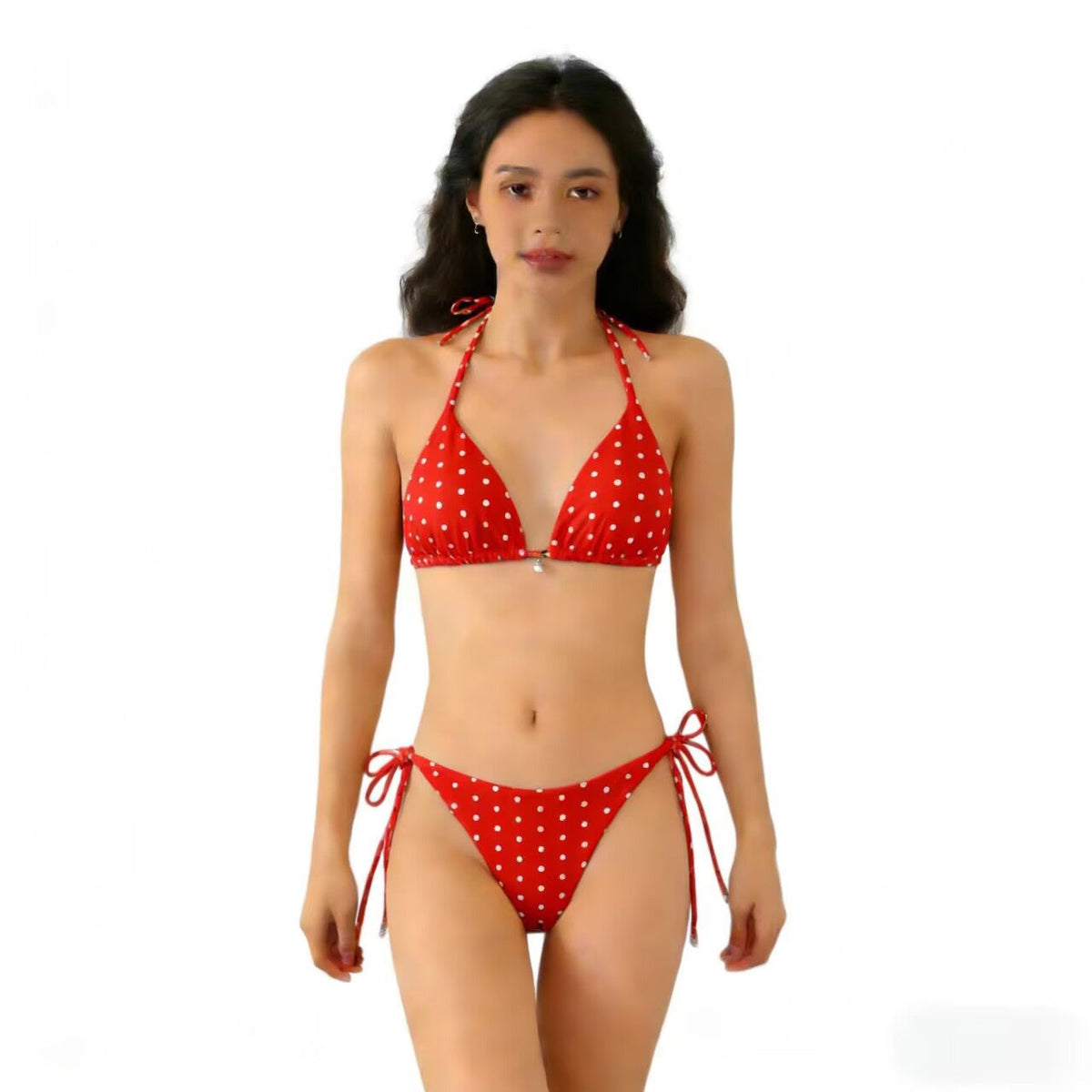 Model wearing a sexy triangle separated strap multicolor polka dot bikini swimsuit on a white background.
