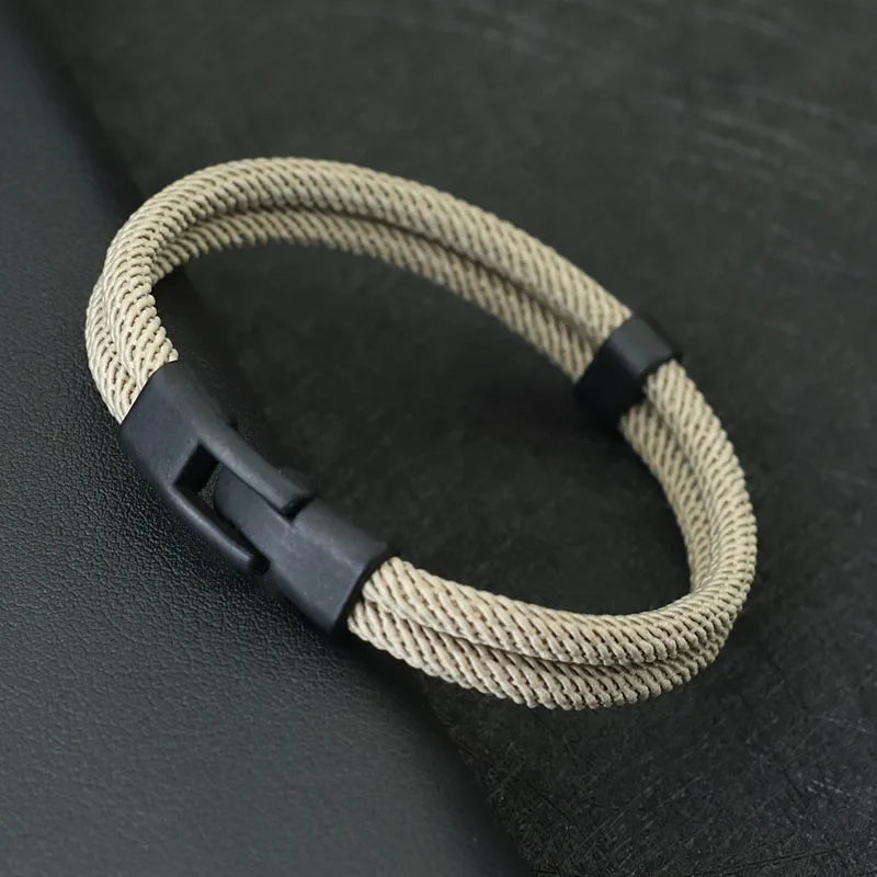 A khaki beige men's double layer rope bracelet with a secure matte black clasp shown on a dark background.