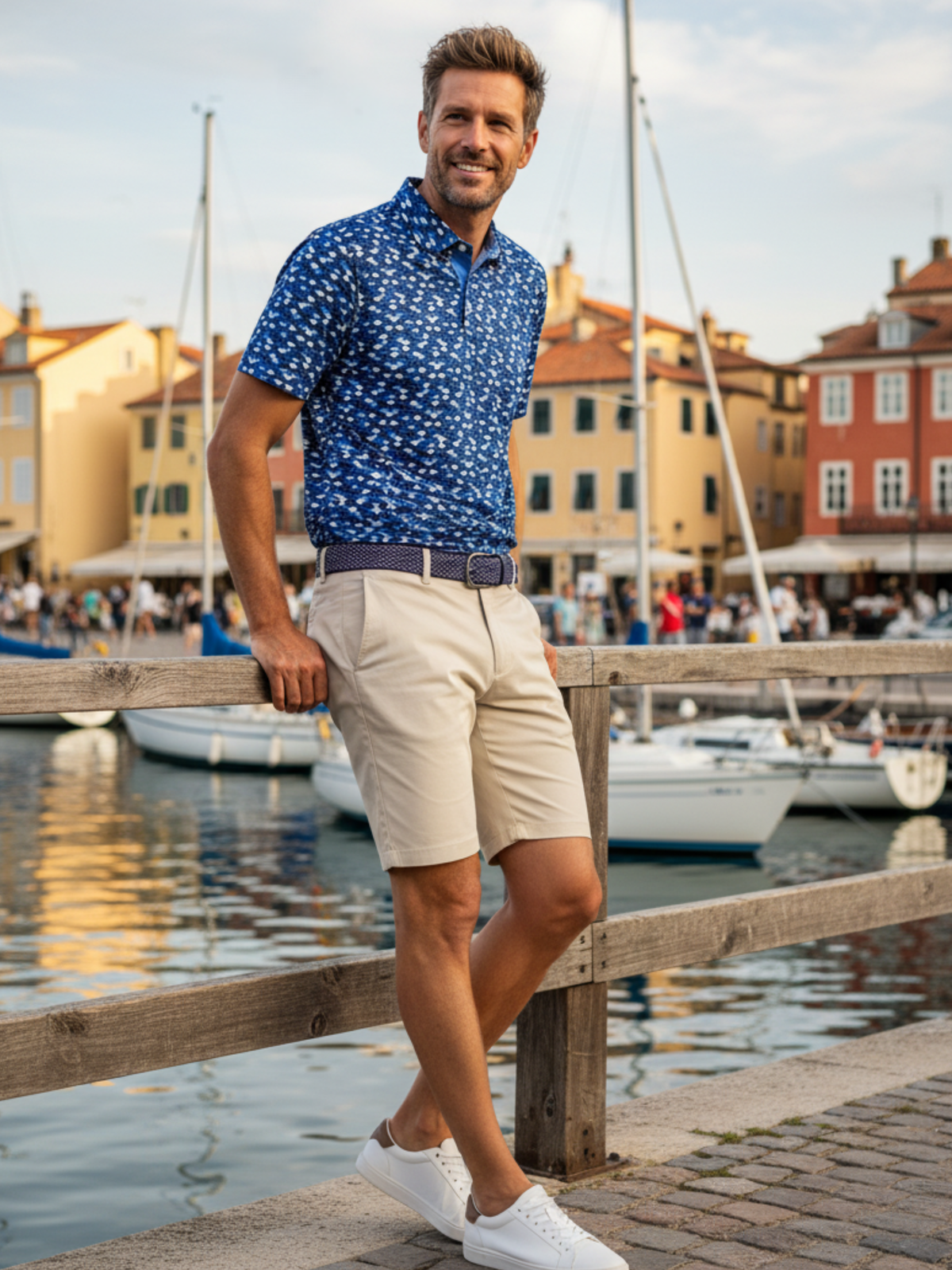 Man wearing lightweight navy performance polo at marina, showcasing stylish and breathable fabric for all-day comfort.