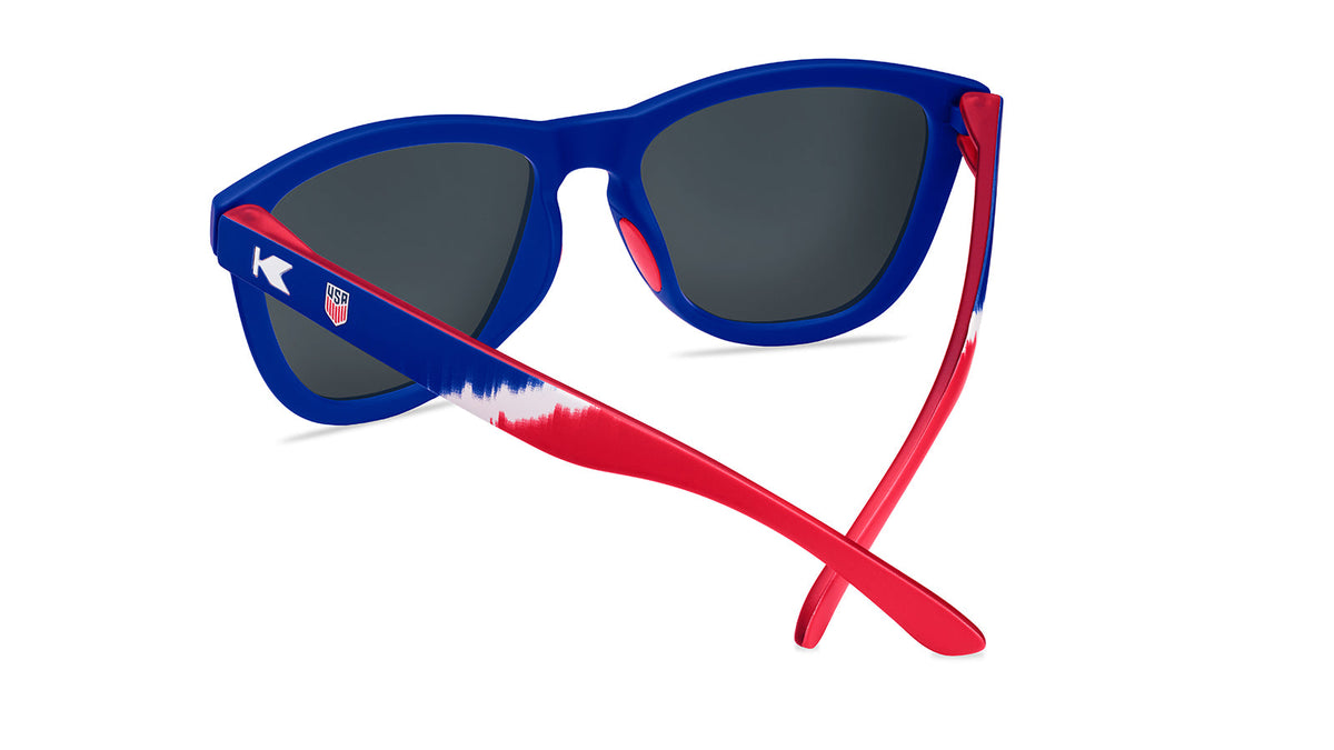 U.S. Soccer 2024 Knockaround Sunglasses with blue frames and red accents, perfect for match-day style.