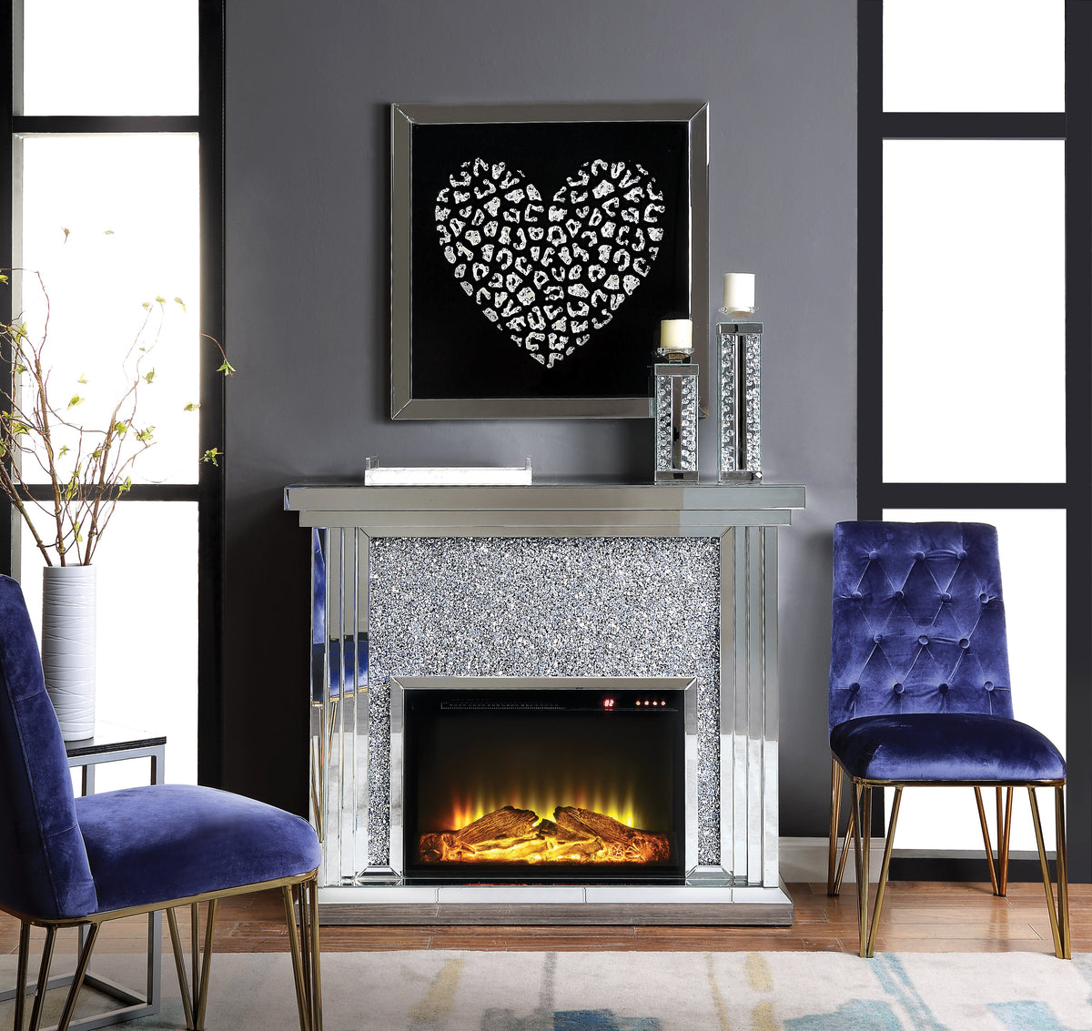 Mirrored Electirc Fireplace with faux diamond inlay in a contemporary living room with blue chairs.