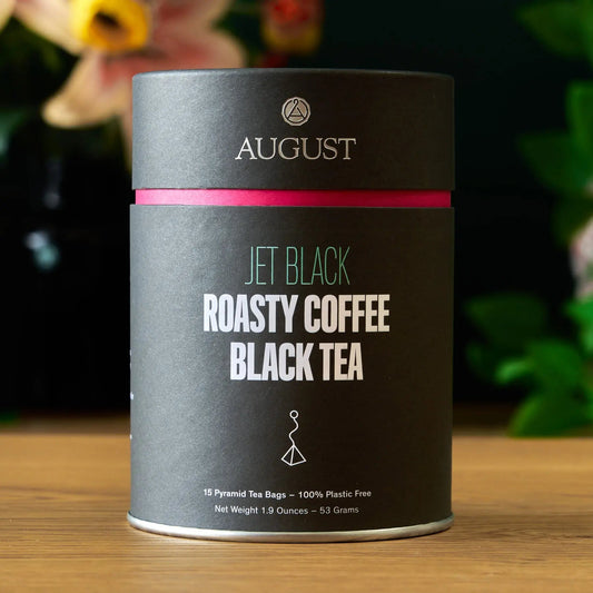 Jet Black Roasty Coffee Black Tea - 15 tea bags packaging displayed against a blurred floral background.