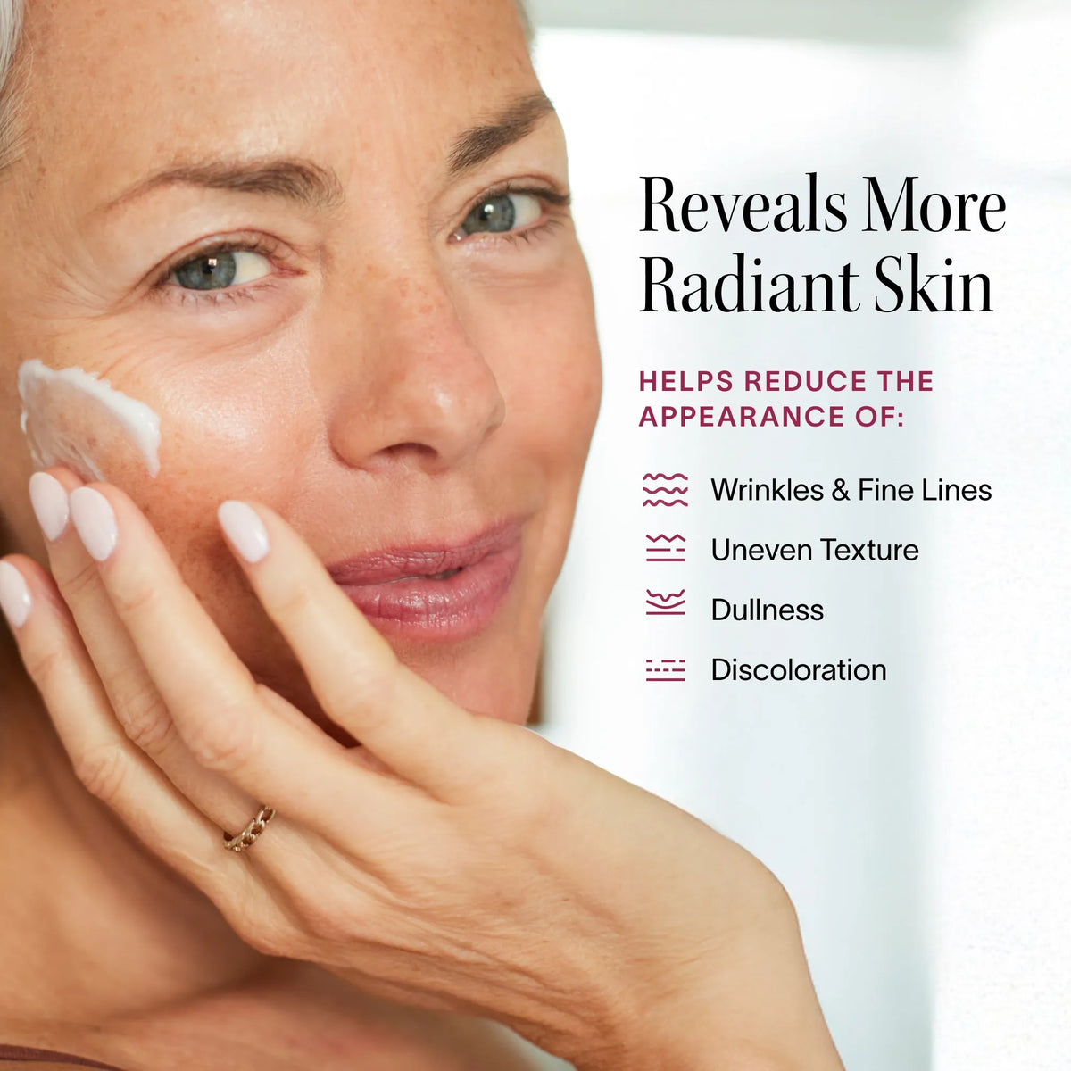 Woman applying light therapy face serum to reduce wrinkles and reveal radiant, youthful skin.