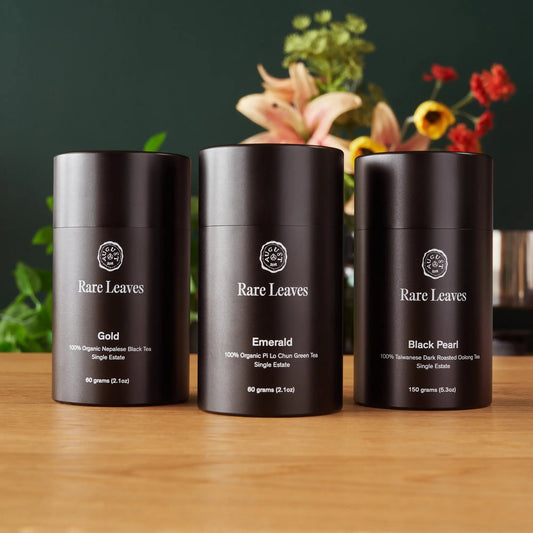 Luxury single origin tea gift set featuring full-size tins of Gold, Emerald, and Black Pearl teas by Rare Leaves.