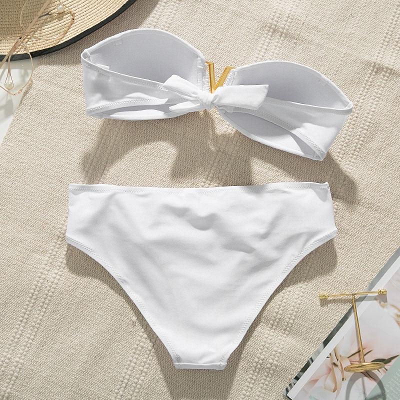 Push up ruffled bikini set featuring a stylish white two-piece bathing suit with bow detail and smooth fabric.