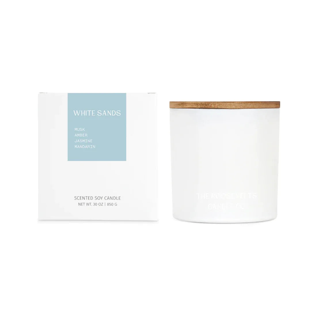 White Sands scented candle in a sleek jar with wooden lid, featuring notes of sea salt, jasmine, amber, and musk.