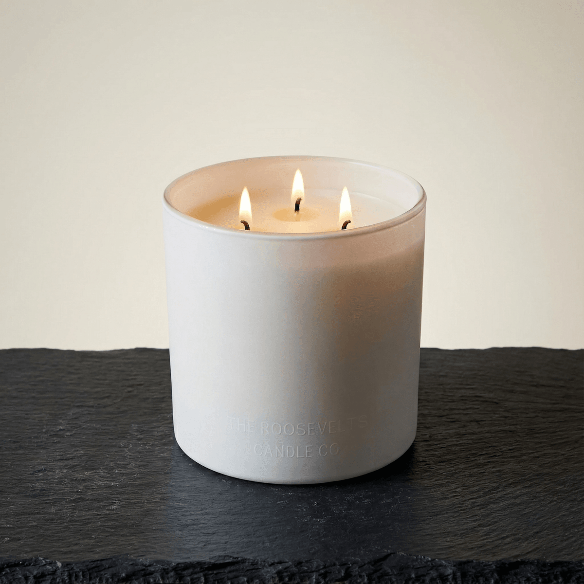 White Sands 3 Wick Candle by The Roosevelts Candle Co, a luxurious white candle with three flickering wicks.